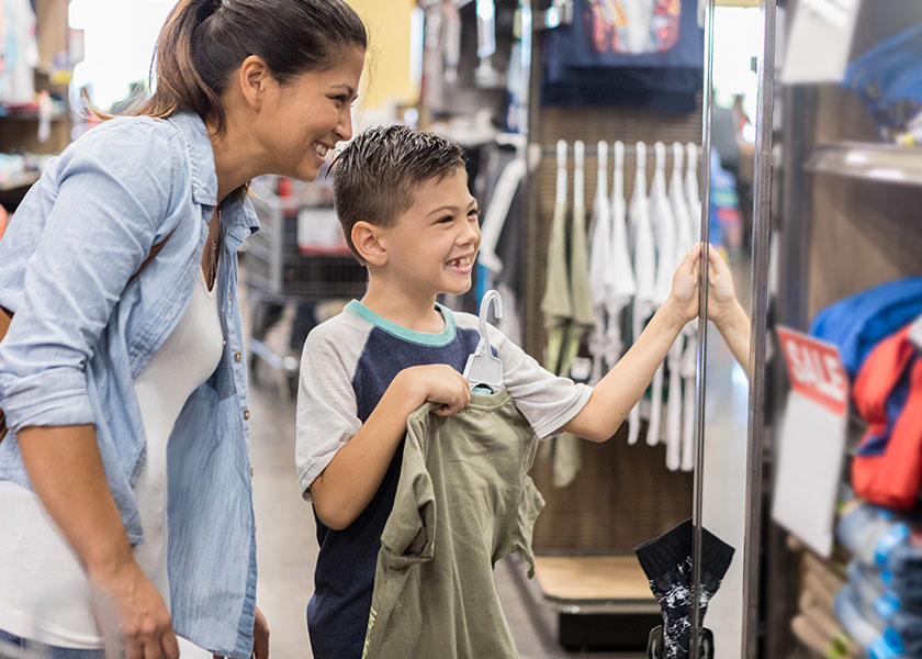 Mom and son shopping for school clothes
